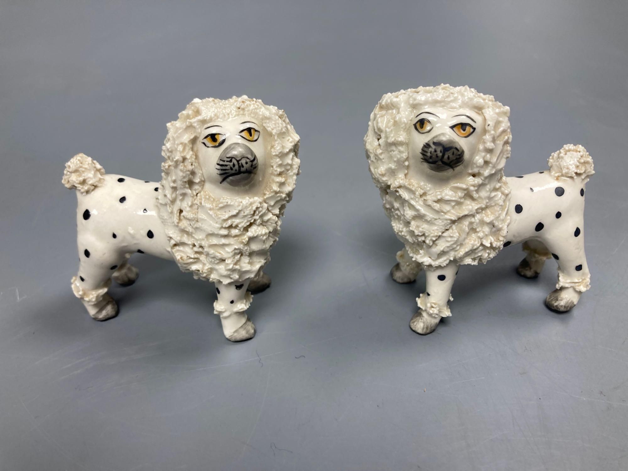 A pair of English porcelain King Charles Spaniels, 6.5cm high and a pair of Continental Dalmatians, 7.5cm high